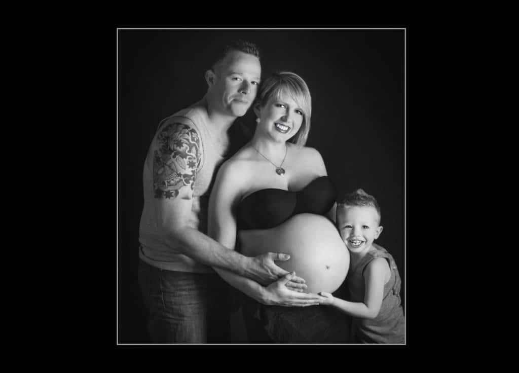 family celebrating pregnancy and expecting their second child