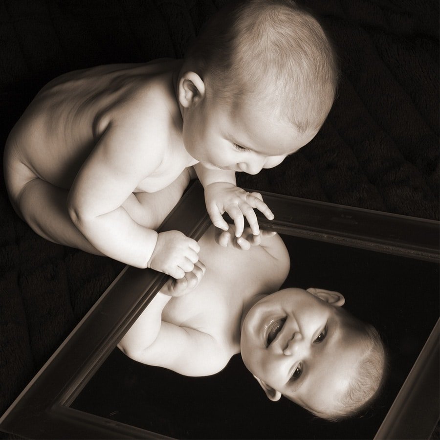 9 months photos looking into a mirror in black and white