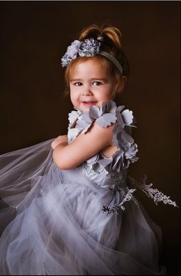 young girl dancing in Lifeworks photography studio in pretty grey dress