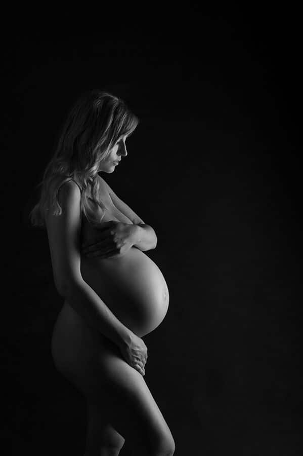 classic black and white studio nude of pregnant woman