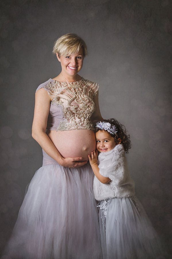pregnant mother and daughter in silver gowns in the studio in Northcote